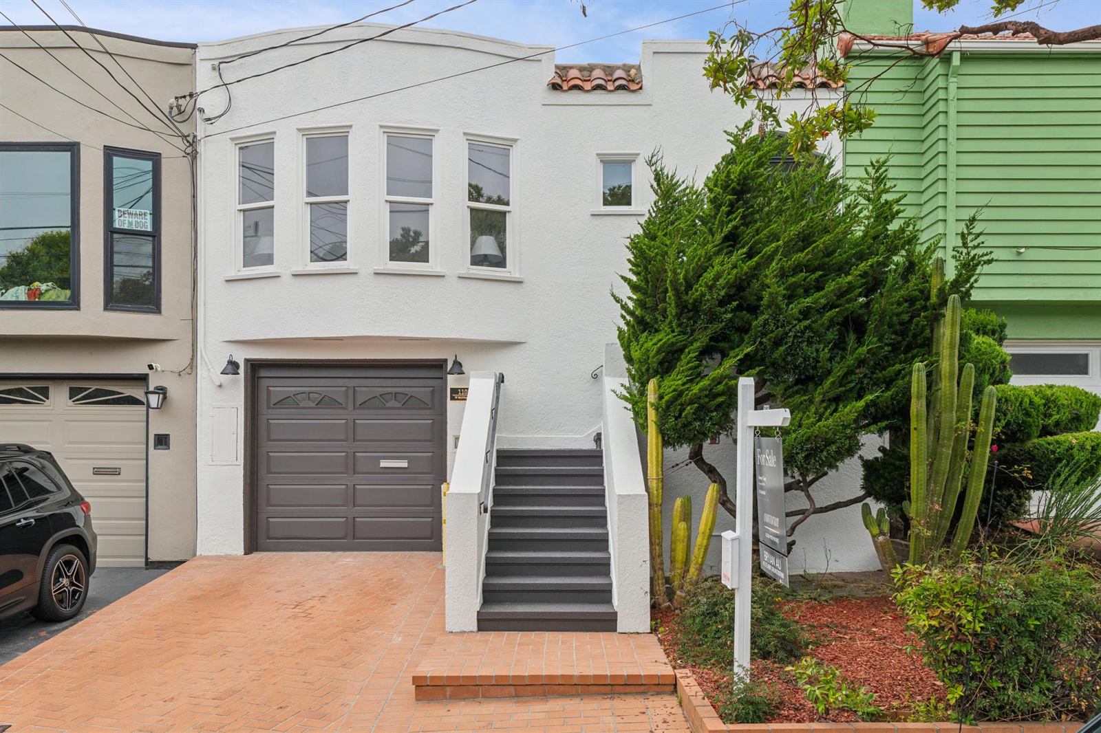 Refinished Mediterranean facade with tile parapet and brick paving, West Moltke Street, Daly City
