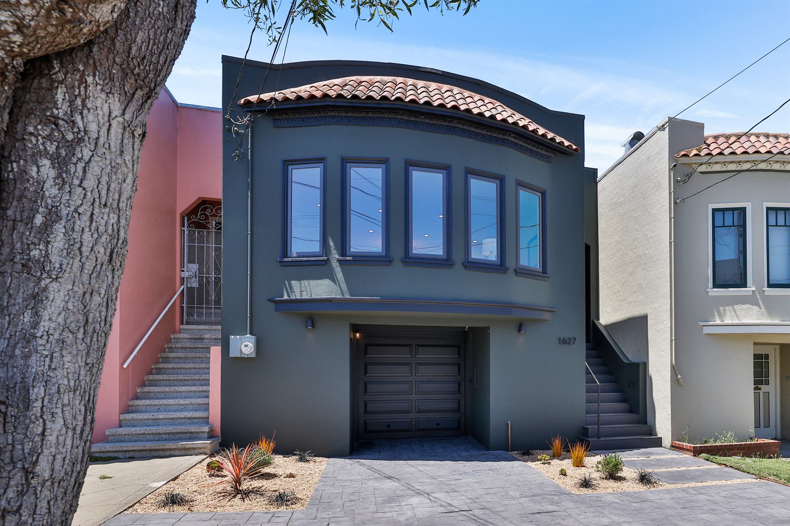 Renovated rowhouse exterior in deep slate with tile cornice, 21st Avenue, San Francisco
